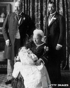 Christening of Prince Edward Albert of York (later King Edward VIII), with Duke of York (later King George V) on the right; the Prince of Wales (later Edward VII) on the left, while Queen Victoria is holding the infant