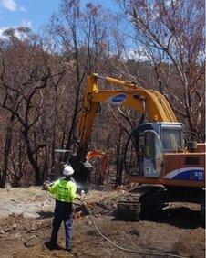 bulldozer, worker and razed ground