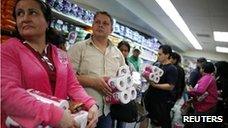 People queuing to buy toilet paper at a supermarket in Caracas