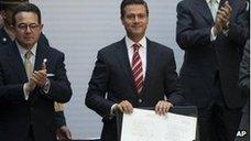 Mexico's president, Enrique Pena Nieto, shows signed education reform document in February