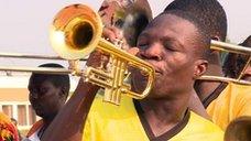 Ghana fan plays trumpet