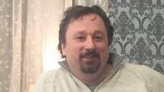 Christopher Sidle with a goatee beard and moustache, wearing a white fleece.