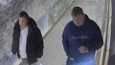 CCTV image of two teenagers walking side by side. The girl on the left is wearing grey leggings and a black fur-hooded coat and the boy on the right in a navy McKenzie tracksuit with blond hair.