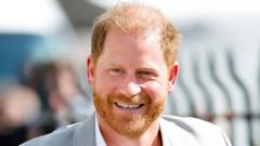 Prince Harry in light grey suit smiles at the camera
