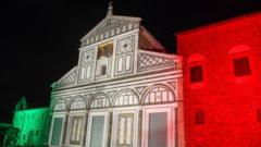 Basilica di San Miniato al Monte in Florence lit up in the colours of the Italian flag