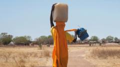 Sudanese woman carrying water