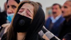 Woman reacts during the mass funeral in Kocho on 6 February 2021