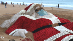 A giant sand sculpture of Santa Claus on the beach of Bay of Bengal in Odisha state, India. Photo: 24 December 2021