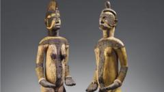 Di wooden objects, one male and one female, represent deities from di Igbo community.