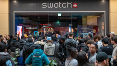 Hundreds of people queuing outside a Swatch store in the UK for the limited edition £335 MoonSwatch watch, causing store closures.