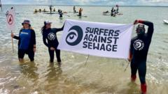 Paddleboarders and surfers protest over sewage