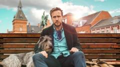 A man sat on a bench with a dog.