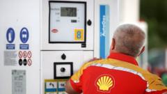 Shell gas station worker uses fuel distributor in Poland in May 2022