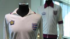 England's first black player Anderson to sell historic shirt