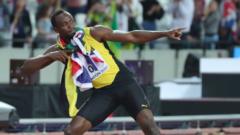 Usain Bolt stands on a running track leaning backwards and pointing one arm outstretched and the other bent pointing in the same direction.