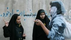 Iranian morality policewomen speak to a woman about her dress in Tehran, Iran (22 April 2007)