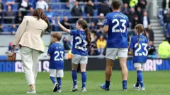 Seamus Coleman and his family walk around the pitch and applaud fans at Hill Dickinson Stadium