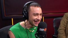 Beaming Olly Alexander unveils UK Eurovision song on Radio 2