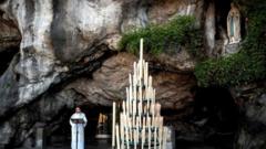 Rector Olivier Ribadeau Dumas conducts a small mass at the deserted Grotte de Massabielle in the Sanctuary of Our Lady of Lourdes on April 9, 2020 in Lourdes