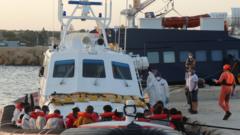 The patrol boat of the Italian Coast Guard loaded with rescued migrants arrive at the port in Lampedusa, Italy, 30 August 2020.