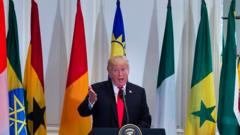 Donald Trump speaks with African flags in the background