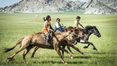 Mongolian children riding horses