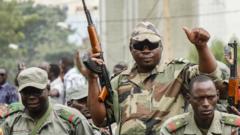 Crowds cheer as soldiers parade in vehicles in Mali