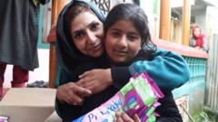 Irfana Zargar hugging a teenager who just got sanitary pads from her