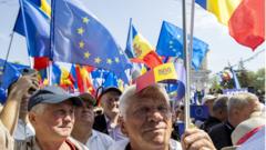 People wave EU and Moldovan flags during a pro-European rally in Chisinau on Sunday