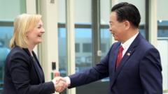 Liz Truss shakes the hand of Taiwan's Foreign Minister Joseph Wu