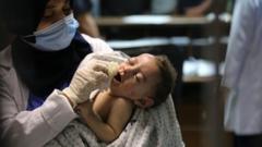 A baby injured in Israeli attack carried out to home of Palestinian Abu Khatab Familiy living in Al-Shati Camp in Gaza Strip, being brought to Shifa Hospital on May 15, 2021, in Gaza City, Gaza