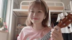 Zheng Linghua with a ukulele in her room