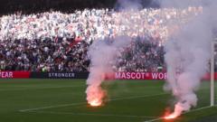 Ajax v Feyenoord abandoned after fans throw flares