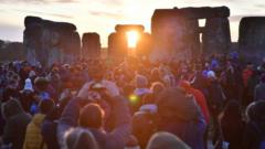 People gather at Stonehenge in Wiltshire to mark the winter solstice, and to witness the sunrise after the longest night of the year. PA Photo. Picture date: Sunday December 22, 2019.