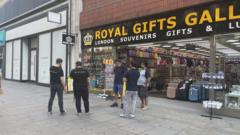 Five men outside shop on Oxford Street