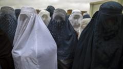 Afghan women wait to cast their ballot at a polling station in Mazar-i-sharif April 5, 2014.