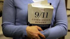 Carie Lemack, who lost her mother Judy Larocque in the 9/11 World Trade Center attack, holds a copy of the 9/11 Commision Report during a press conference November 30, 2004