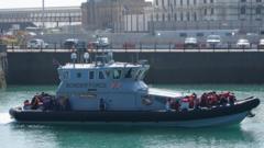 A group of people thought to be migrants are brought in to Dover, Kent, by Border Force officers, following a small boat incident in the Channel.