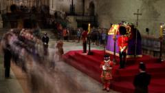 Crowds file past the Queen as she lies in state