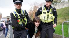 Police detain a protester in York