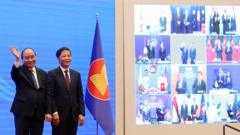 Vietnam"s Prime Minister Nguyen Xuan Phuc (L) and Minister of Industry and Trade Tran Tuan Anh (R) cheer after the virtual signing ceremony for the Regional Comprehensive Economic Partnership (RCEP) in Hanoi, Vietnam, 15 November 2020.