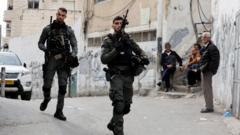 Israeli Border police officers walk outside a house in East Jerusalem