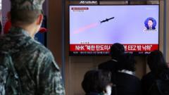 People watch a TV broadcasting a news report on North Korea firing ballistic missiles into the sea, in Seoul, South Korea, November 2, 2022.
