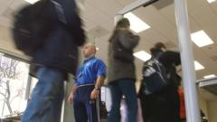Security supervisors Franco Poerri (C) stands guard as students walk through metal detectors at William Howard Taft High School February 14, 2002 in Chicago, IL.