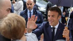 French President Emmanuel Macron greets supporters as he leaves after voting in the second round of French parliamentary elections, at a polling station in Le Touquet-Paris-Plage, France, June 19, 2022.