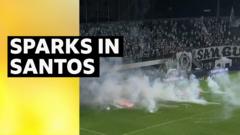 Chaos as fans throw rockets onto pitch in Brazil