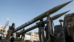 Palestinian militants from Hamas's military wing, the Izzedine al-Qassam Brigades, display a Qassam rocket at a parade in Rafah, southern Gaza, on 21 August 2016
