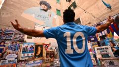 Fan in front of Maradona mural in Naples