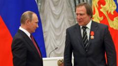 Russian President Vladimir Putin gives an order to businessman and cellist Sergei Roldugin during the state awarding ceremony at the Kremlin in Moscow, Russia, on 22 September 2016
