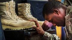 A US soldier from the 3rd Cavalry Regiment pays his respects during a memorial for Specialist Wyatt Martin and Sergeant First Class Ramon Morris at Bagram Air Field in Afghanistan, on December 23, 2014